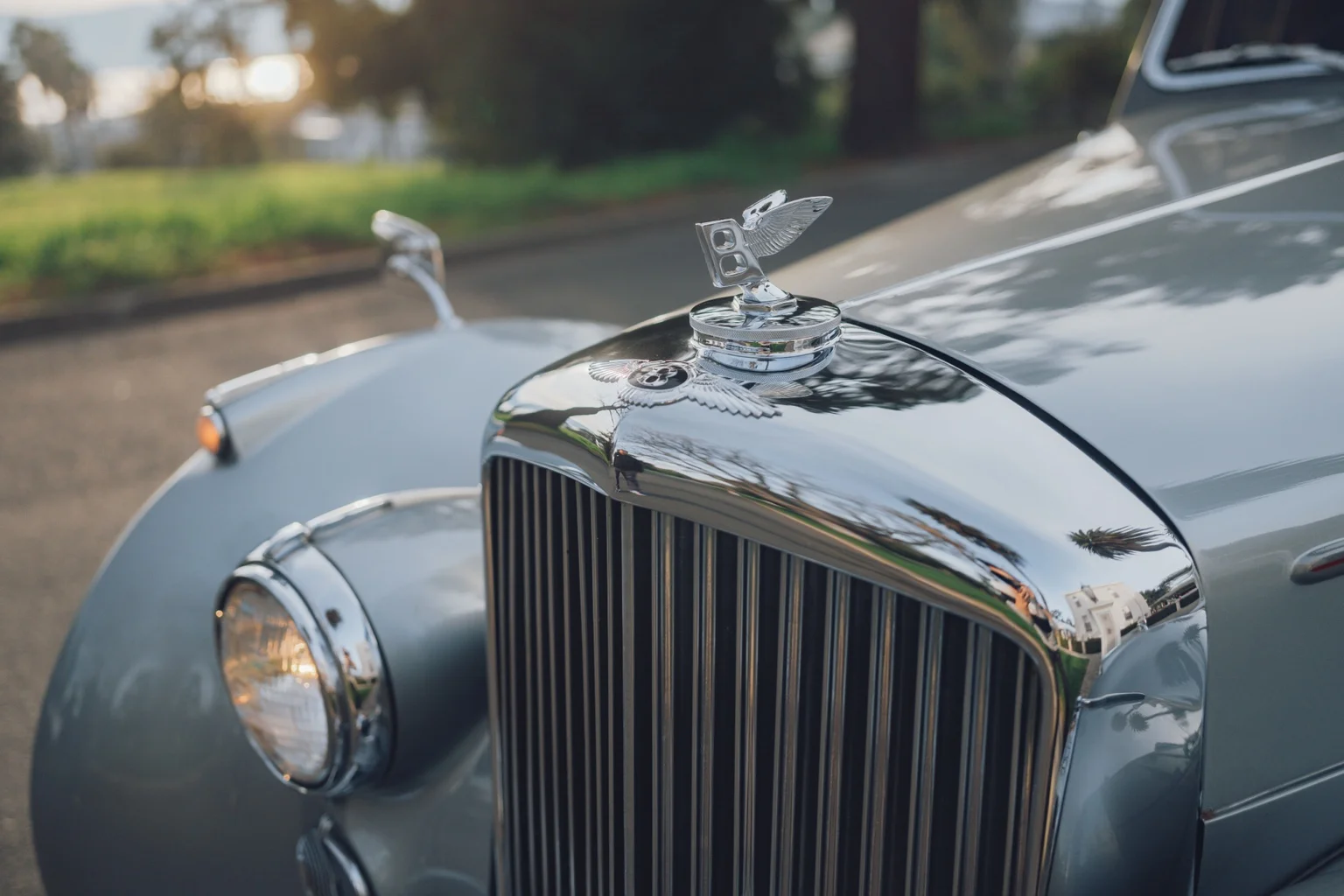 Close-up of the winged Bentley hood ornament and chrome grille